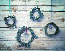 Advent Wreaths Hanging From Strings On Wooden Wall