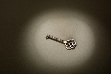 old vintage key on paper background.