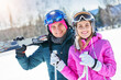 © Kalim - Young couple having fun while winter skiing