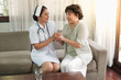 © u photostock - Female nurses take care of senior woman at home