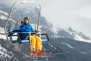 Wall Mural - Skier man on ski chair lift