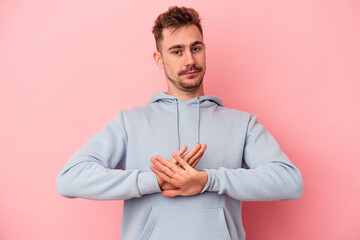 Young caucasian man isolated on pink background doing a denial gesture