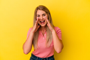 Wall Mural - Young russian woman isolated on yellow background shouting excited to front.