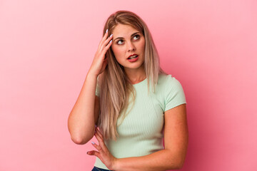 Wall Mural - Young russian woman isolated on pink background being shocked, she has remembered important meeting.