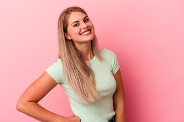 Wall Mural - Young russian woman isolated on pink background confident keeping hands on hips.