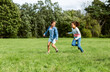 © Syda Productions - childhood, leisure and people concept - happy girls playing tag game and running at park