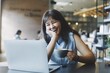 © Mallika - woman talking video call in cafe