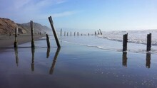 Surf And Wooden Posts On Fort Funston Beach, San Francisco