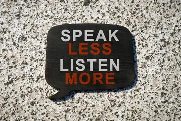 Quote bubble with phrase speak less listen more.