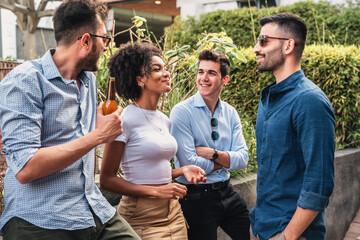 Wall Mural - Group of multicultural young people hangout drinking beers and talking outdoors - meeting between friends in the park