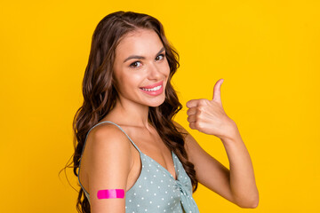 Sticker - Photo of young brunette woman show thumb up wear dotted singlet vaccine isolated on yellow color background