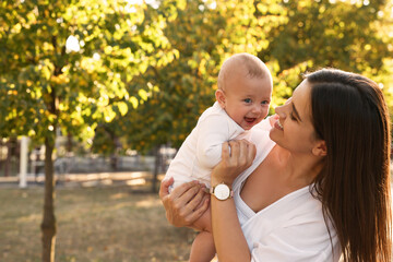 Canvas Print - Young mother with her cute baby in park on sunny day