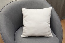 White Square Canvas Pillow Mockup On Grey Armchair, Small Cotton Cushion Mockup In Living Room Interior.