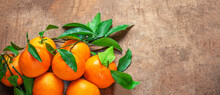 Mandarin Oranges Fruits Or Tangerines With Leaves On A Wooden Table. Copyspace. Fresh Picked Mandarins Top View. Wallpaper