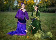 Women In 19th Century Costumes Play Croquet In The City Park
