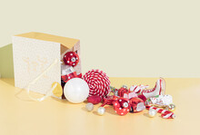 Christmas Decorations Spilled From The Gift Bag On The Gold Background. Christmas And New Year Holidays Concept.