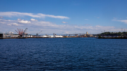 Wall Mural - Seattle, Washington, USA - June 4 2021: Mount Rainier and Seattle Logistics shipping terminals waterway. View from Elliott Bay during summer.