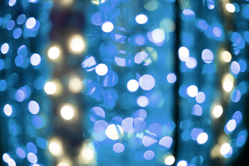 bright blue lights bokeh effect from festive garland light unfocused blurred abstract