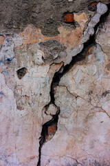 Sticker - Cutting cement plaster with a crack in the old wall.