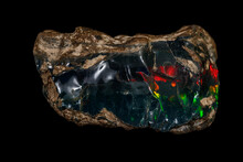 Macro Stone Opal Mineral In Rock On A Black Background Close Up