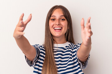 Wall Mural - Young caucasian woman isolated on white background celebrating a victory or success, he is surprised and shocked.