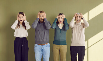 Group of adult people feeling surprised, shocked, anxious and scared. Four male and female corporate office workers panicking because of deadline or unexpected troubles at work. Fear and panic concept