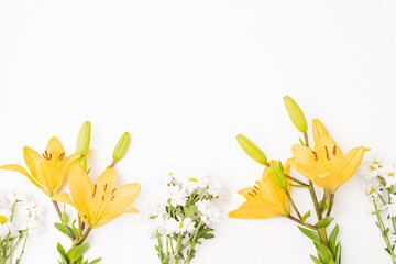 Wall Mural - flat lay frame with yellow lilies on white background