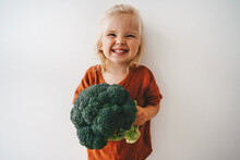 Child With Broccoli Vegetable Healthy Food Vegan Cooking Eating Sustainable Lifestyle Organic Veggies Harvest Plant Based Diet Nutrition Funny Kid Girl Happy Smiling Toddler
