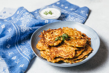 Potato pancakes Latkes on white table background. Traditional Jewish festive food for Hanukkah holiday. Jew festival of lights.