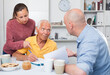 © JackF - Adult children help an older father sign documents. High quality photo