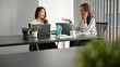 Elegant businesswomen working together in board room