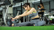 Sporty asian girl stretching her body at the gym. exercise concept.
