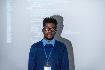 Poster - Young confident it-manager or software developer standing against interactive screen with decoded data