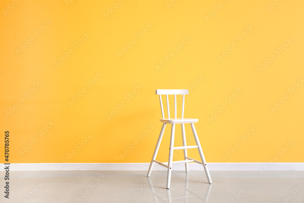 Modern chair near yellow wall