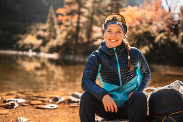  Young traveler hiking girl with backpacks. Hiking in mountains. Sunny landscape. Tourist traveler on background view mockup. High tatras , slovakia