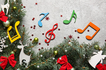 Christmas decor, fir branches and note signs on light background, closeup