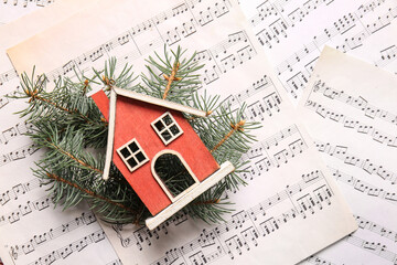 Poster - Wooden toy house and fir tree branches on note sheets, closeup