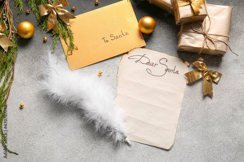 Letter with text DEAR SANTA, envelope with text TO SANTA and Christmas decor on grey background