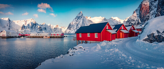 Wall Mural - Panoramic winter cityscape of small fishing town - Hamnoy, Norway, Europe. Wonderful morning seascape of Norwegian sea. Amazing landscape of Lofoten Island with snowy country road.