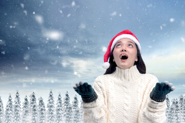 Canvas Print - Asian woman with winter gloves and Santa hat standing