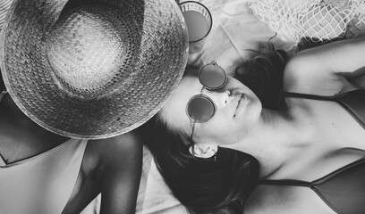 Wall Mural - Cheerful girls in swimsuit sun tanning together