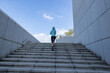 © lzf - Fitness sports woman running up stairs in city