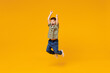 © ViDi Studio - Full body overjoyed excited little small happy boy 6-7 years old wearing green t-shirt jump high with outstretched hands isolated on plain yellow background Mother's Day love family lifestyle concept