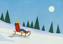 Carefree Woman Sledding On Snowy Slope

