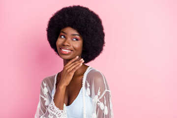 Sticker - Photo portrait curly woman smiling dreamy touching chin looking blank space isolated pastel pink color background