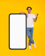 Poster - Yes. Man leaning on blank empty cellphone screen celebrating success