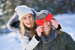 © Kalim - Couple with red hearts in winter snowy scenery