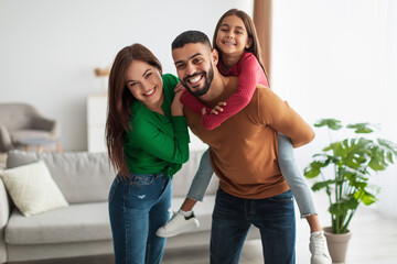 Wall Mural - Portrait of cheerful happy Arab family having fun at home