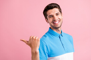 Poster - Photo of funky brunet millennial guy point empty space wear blue t-shirt isolated on pink color background