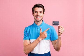 Poster - Photo of optimistic brunet young guy point card wear blue t-shirt isolated on pink color background